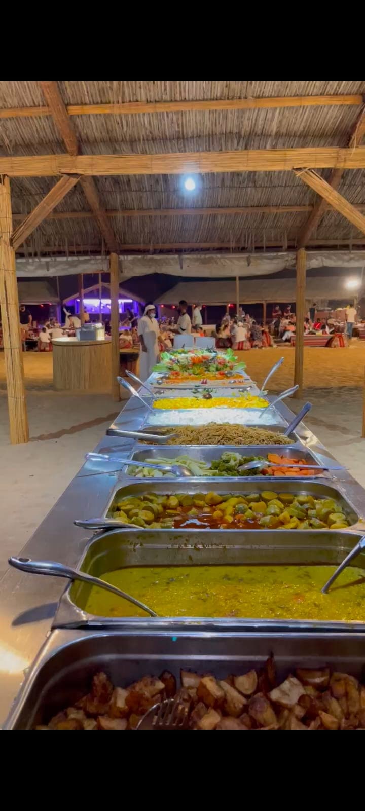 BBQ buffet spread at the desert camp
